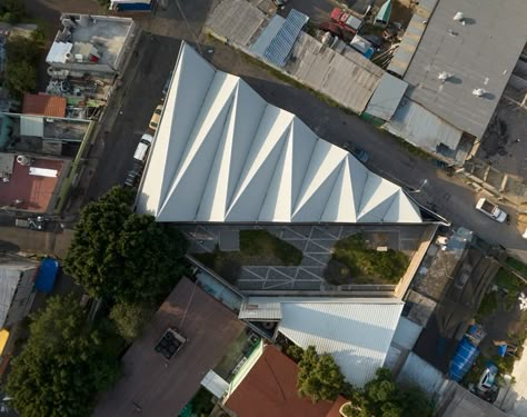 metallic roof shapes triangular folds atop cultural infrastructure in mexico city Industrial Art Studio, Triangular Architecture, Warehouse Architecture, Folding Architecture, Roof Shapes, Architectural Studio, Roof Architecture, Community Space, Urban Fabric