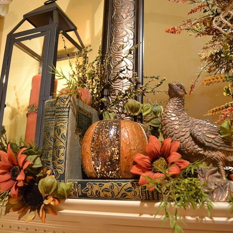 I like the colored candles in the lanterns, the old books and the greens. Autumn Mantel Decor, Mantel Styling, Colored Candles, Mantle Ideas, Easy Fall Wreaths, Fall Fireplace, Fall Vignettes, Fall Mantle, The Mantle