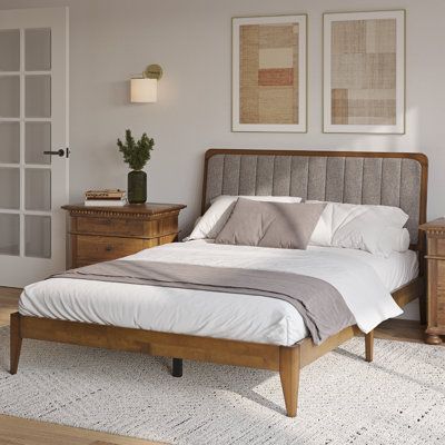 This upholstered bed showcases clean lines and vertical channel tufting for a sophisticated look in your bedroom. Its frame is made from solid wood, and it's accented with a weathered walnut finish that complements the brown and gray polyester upholstery. The headboard is adjustable, giving you the freedom to find the perfect height for your comfort. Plus, it comes with four center support legs that provide additional balance, while tapered feet add a touch of elegance. This bed requires a box s Solid Wood Headboard, Headboard Bed Frame, Bed Bases, Headboard Bed, Set Meja Makan, Kursi Bar, Adjustable Bed Base, Teen Bedroom Furniture, Wood Bed Frame