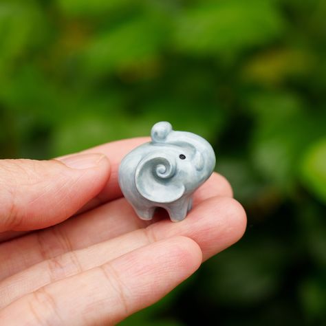 "A tiny ceramic elephant figurine This elephant is crafted from fine porcelain, and meticulously hand painted in detail with great quality, highly collectible. He is the perfect for any miniature collector or elephant lover. Dimensions -- TINY GREY ELEPHANT FIGURINE: 0.7\" (1.8 cm) - 0.75\" (1.9 cm) -- TINY GREY ELEPHANT NECKLACE: Each charm is about 0.7\" (1.8 cm) - 0.75\" (1.9 cm) Chains are custom in 14 - 18 inches. -- Materials-- Pendant: Porcelain Clay, High Glaze The chain is made of high Elephant Clay, Clay Elephant, Elephant Pottery, Gifts For Best Friends, Tiny Elephant, Ceramic Elephant, Beading Jewelery, Grey Elephant, Elephant Lover