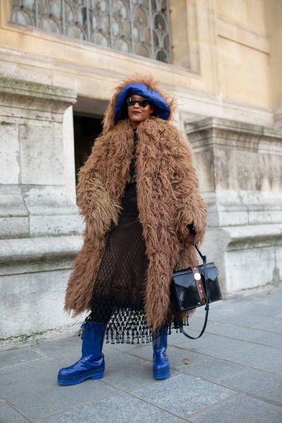 MICHELLE ELIE is seen on the street attending Iris van Herpen during Paris Haute Couture Fashion Week wearing shag fur brown coat, blue hat and shoes with black bag and brown dress on January 21, 2019 in Paris, France. (Photo by Matthew Sperzel/Getty Images) Michelle Elie, Paris Haute Couture, Long Faux Fur Coat, Iris Van Herpen, January 21, Brown Coat, Blue Hat, Brown Dress, Black Bag