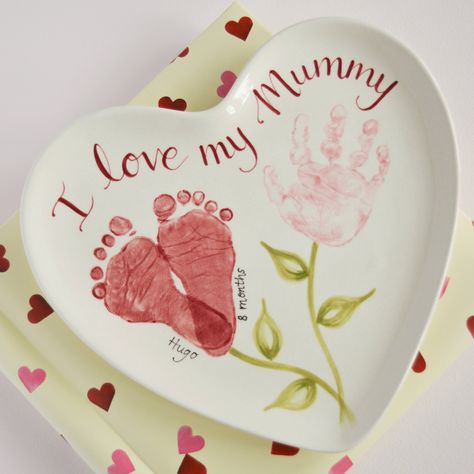 Create a beautiful keepsake for Mothers Day with your babies hand and footprints. This heart shaped plate was made to coordinate with an existing collection of pottery. Mother’s Day Hand And Footprint Art, Handprint Plates Mothers Day, Valentines Day Keepsakes Kids, Mother’s Day Projects For Infants, Footprint Crafts For Mother's Day, Handprints And Footprints Crafts, Craft Ideas For Newborns, Mothers Day Gifts Infants, Baby Handprint Crafts Valentines Day