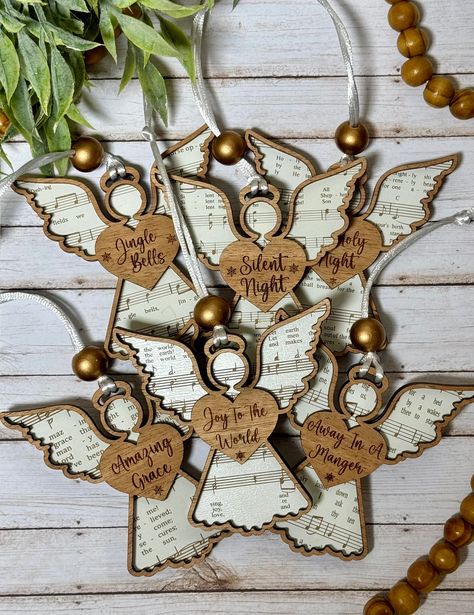 These special angel ornaments are laser cut and engraved and feature one of 6 hymns on the angels. DETAILS: * SIZE:  approximately 4" tall x 3.5" wide * COLOR:  mahogany outline, white angel (see pics for texture and slight gloss sheen) * Includes string hanger * Back of ornament is white   --> Please note:  No two ornaments will be identical since wood varies, but we try our best to make them as close to the original listing photos as possible.   All of our ornaments are fully customizable too! 2024 Ornaments, Angel Ornaments Diy, Sheet Music Ornaments, Diy Christmas Angel Ornaments, Wooden Angels, Diy Angel Ornaments, Christmas Angel Decorations, Hark The Herald Angels Sing, Craft Ornaments