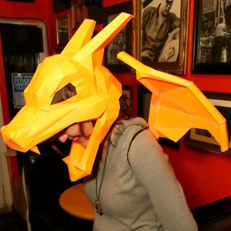 Test out your origami skills by crafting yourself a paper Pokemon mask! These wearable masks are easy to piece together with step by step instructions available to instantly download. All you need is paper, scissors, tape and a few short hours. Pokemon Masks, Papercraft Pokemon, Cardboard Props, Paper Masks, Pokemon Charizard, Gaming Merchandise, Shiny Pokemon, Pokemon Cosplay, Head Mask