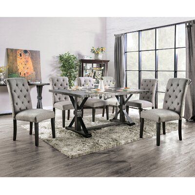 This dining set brings a traditional and cohesive look to your dining room. It includes one table and six chairs, all made from a blend of solid rubberwood and engineered wood in an antique black finish for a vintage-inspired design. The table comes with a rectangular surface that features a plank-style top, and a trestle base with x-cross supports. Each of the six chairs is wrapped in a polyester blend and comes with a padded seat for cushioned support during any meal. Plus, we love that the bu Rustic Dining Set, Round Dining Table Sets, 7 Piece Dining Set, 5 Piece Dining Set, Furniture Of America, Rustic Dining, Round Dining, Round Dining Table, Room Set