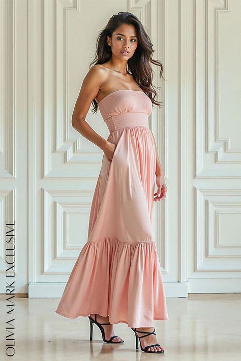 Its blush hue whispers of springtime romance, while the ruched bodice and fluid skirt create a silhouette that is both timeless and modern. The gown's ethereal layers cascade like gentle waves, promising movement and grace. Designed to accentuate the feminine form, it is a garment that radiates confidence and allure. It is not just a dress; it is an embodiment of understated luxury, a piece that invites admiration and ignites enchantment. Understated Luxury, Strapless Maxi, Ruched Bodice, Strapless Maxi Dress, Olivia Mark, Side Pocket, Elegant Dresses, Blush Pink, Ruffles