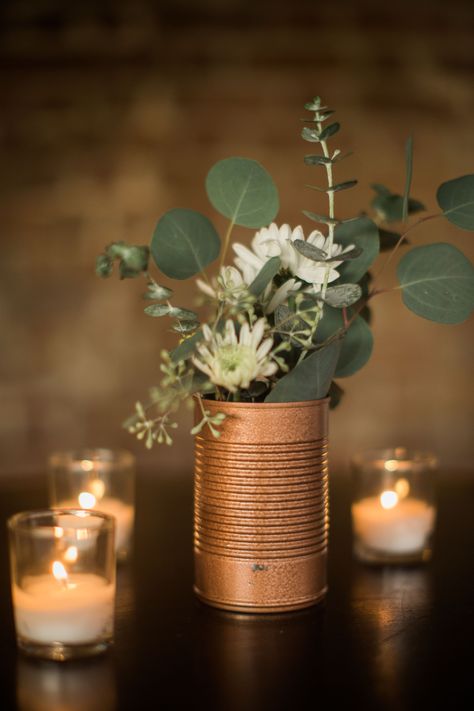 “Keeping in line with our budget, we had friends and family collect soup cans,” Charlee-Ann says. Although it was an unusual request from a bride, Charlee-Ann had a plan to spray-paint the cans an elegant copper color and use them as vases for the reception table centerpieces. Industrial Wedding Centerpieces, Gold Spray Paint Diy, Painted Tin Cans, Wedding Lantern, Wedding Burlap, Lantern Centerpiece, Winter Centerpieces, Boda Diy, Lantern Christmas