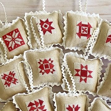 Erica Arndt on Instagram: "The 2022 CLASSIC STITCHY ORNAMENTS are live!! These adorable cross-stitch ornaments are sure to brighten up your holidays! They finish at 3-1/2" square and are based on classic quilt blocks. Of course, they go perfectly with the Classic QUILTY Ornaments too! I used two reds and Wichelt Beautiful Beige fabric, but you can make them any color you like. They are perfect for stash busting and cute as can be! I also have a YT Video on how to finish these so grab your supplies and come Stitch With Me!⁠ 🧵🎄🧵🎄🧵🎄⁠ PATTERN: Classic Stitchy Ornaments⁠ FABRIC: Wichelt Beautiful Beige⁠ FLOSS: @dmc_embroidery ⁠ (click the bio ☝🏻 then click Shop or YouTube! store.confessionsofahomeschooler.com)⁠ 🧵🎄🧵🎄🧵🎄⁠ #ericaarndt #howtocrossstitch #classicchristmas #classicstitchy Erica Arndt, Classic Quilt Blocks, Stitch Ornaments, Red Cross Stitch, Christmas Quilt Blocks, Holiday Sewing, Felt Crafts Christmas, Happy December, Classic Quilts