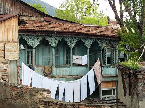 Blue Balcony, White Sheets, Sololaki, Tbilisi, Georgia  The architecture in Tbilisi is a mixture of local (Georgian), with strong influences of Byzantine, European/Russian (neo-classical), and Middle Eastern architectural styles. The oldest parts of town, including the Abanot-Ubani, Avlabari, and to a certain extent the Sololaki districts clearly have a traditional Georgian architectural look with Middle Eastern influences. Blue Balcony, Georgia Country, Georgian Architecture, Georgia Travel, Tbilisi Georgia, Neo Classical, Architectural Styles, White Sheets, House Portraits