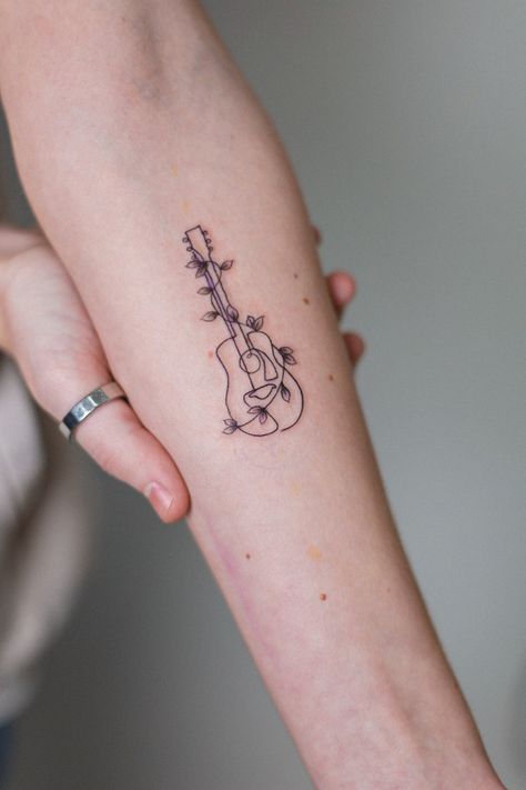 Mini Forearm Tattoo, Guitar Tattoo Forearm, Fineline Guitar Tattoo, Pretty Music Tattoos, Guitar Tattoo Design Ideas, Music Tattoo For Women, Line Art Guitar Tattoo, Guitar And Music Tattoo, Ukulele Tattoo Ideas