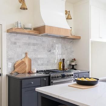 Wall Sconces Above Kitchen Floating Shelves Design Ideas Blue Kitchen Island, Kitchen Island Tops, Kitchen Floating Shelves, Light Gray Cabinets, Oak Floating Shelves, Hood Vent, Grey Kitchen Designs, Wood Range Hood, French Oak Flooring