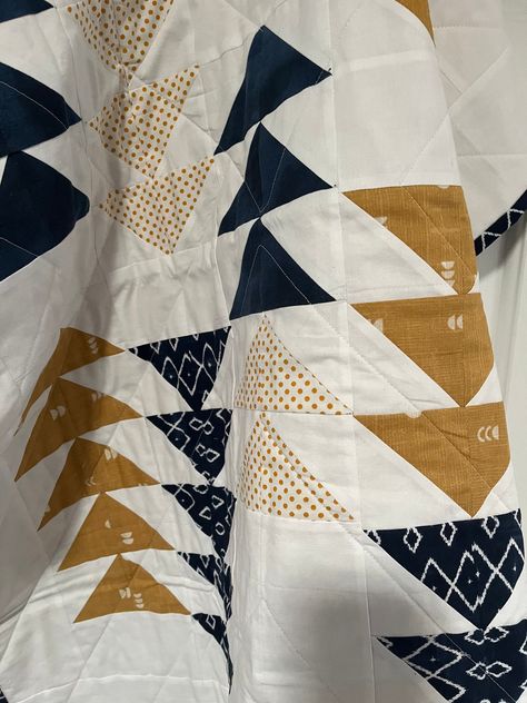 "This modern design gender neutral quilt measures 32x36\" and features an arrangement of small flying geese(goslings)  surrounded by white sashing in navy and gold fabrics. The middle or batting layer is warm and natural cotton batting.  The bottom or backing uses a navy/white geometric print.  All fabrics have been prewashed to remove excess dyes and starches. This quilt machine machine quilted for durability using a diagonal \"V\" design and white thread.  The quilt features a double fold bind Orange And White Quilts, Stack And Wack Quilts, Flying Geese Quilt Ideas, Boho Quilt Pattern, Geometric Quilt Patterns, Neutral Quilts, Gold Fabrics, Modern Baby Quilt Patterns, Gender Neutral Quilt