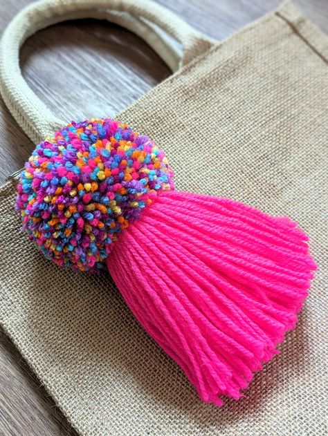 Add a touch of pink and vibrant colours to a bag or garment with this unique soft and pretty hand made pom pom tassel key chain. These can also be made to order so if you would like a different amount, size or colour change, please message me 🙂 Carefully crafted from Acrylic yarn this multicoloured pom pom with bright pink tassel has a diameter of approx 9cm and length of approx 20cm including chain and ring. The silver colour chain and 2.5cm split ring is ideal for attaching to many items and apparel. Perfect for a gift, stocking filler or a little treat for yourself. Carefully packed into a box for transit. Thank you. Wool Crafts Diy, Pom Pom Bag Charm, Tassel Bag Charm, Yarn Pom Pom, Paper Diy, Pink Tassel, Tassel Keychain, Pretty Hands, Wool Crafts