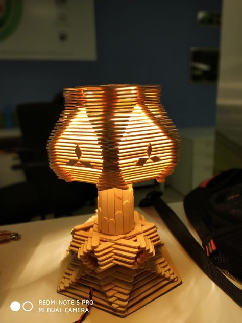 Popsicle stick night lamp..  Item used: 1. popsickle stick nearly 500 numbers. 2. Fevicol  3. Glue gun and glue 4. Wire, plug, bulb holder and bulb