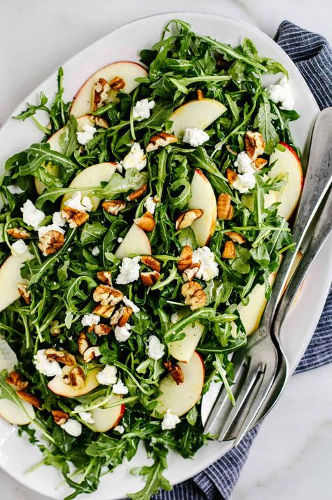 This Arugula Apple Salad has it all: peppery arugula, crisp apple slices, buttery pecans, and creamy goat cheese in a tangy, honey-sweetened dressing. Made in just 15 minutes, this salad is special occasion worthy and weeknight easy! Arugula Walnut Salad, Arugula Green Apple Salad, Arugula Apple Salad Recipes, Arugula Apple Walnut Salad, Roasted Apple Salad, Apple Brie Salad, Arugula Salad Apple, Arugula Salad Fall, Arugula Salad With Goat Cheese