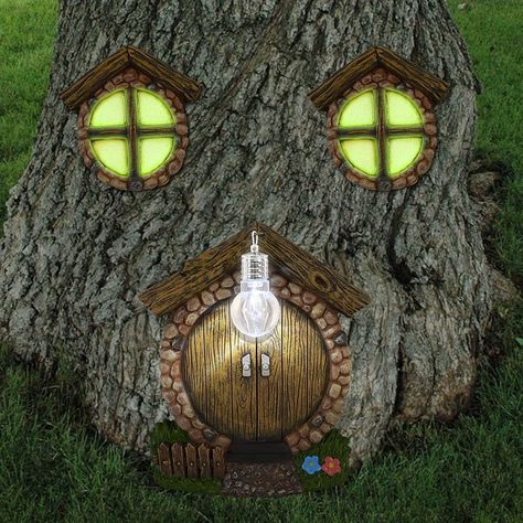 PRICES MAY VARY. Miniature Fairy Garden Door Windows: The fairies are looking for home. Hang these delicate door and windows on the trees in the yard and invite the fairies to stay here. The windows glow in dark and the door with a litter lamp in front of it. Good Halloween decoration. Premium Quality: The miniature fairy garden door and windows are made of high grade resin. It is resistant to sunshine and weatherproof, can last for a long time. The two windows are coated with phosphorescence, w Tree Stump Decor, Dark Fairies, Trees Decoration, Miniature Window, Fairy Doors On Trees, Fairy Gnome, Solar Spot Lights, Fairy Garden Doors, Cozy Garden