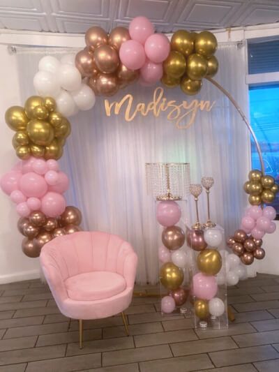 Give your merry moments an extra dash of fun and excitement by setting up highly elegant balloon garland backdrop. Elegantly set a white organza curtain panel on a curtain rod and create a cute balloon backdrop on our round arch. Collect plenty of pastel pink latex balloons, white pearl balloons, gold vinyl balloon and arrange beautifully on the arch. Display clear acrylic pedestal risers & floor stands filled with balloons and top them with tall gold cake & cupcake stand. Arch Photo Backdrop, Arch Display, 22 Bday, Acrylic Pedestal, Round Wedding Arch, Photo Backdrop Stand, Balloons White, Pearl Balloons, Arch Photo