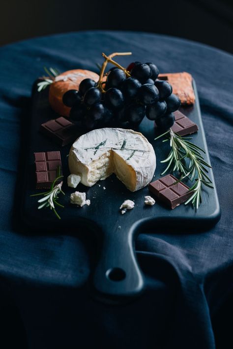 Black wooden cheese board with assorted cheeses, black grapes, dark chocolate, and rosemary, set on a dark tablecloth with moody, ambient lighting. Cheese Board Aesthetic, Cheese Board Ideas, Dark Elements, Board Aesthetic, Wooden Cheese Board, Aesthetic Dark, Board Ideas, Cheese Board, The Beauty