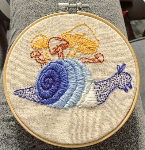 Simple blue and orange mushroom snail #embroidery #crossstitch #snail #mushroom #blue #orange  #art #craft #embroiderystitches #hoop Snail Embroidery, Snail Embroidery Simple, Toadstool Embroidery Simple, Embroidered Snail, Snail Cross Stitch, Snail Mushroom Embroidery, Embroidered Toadstools, Crazy Quilt Stitches, Embroidery Lessons