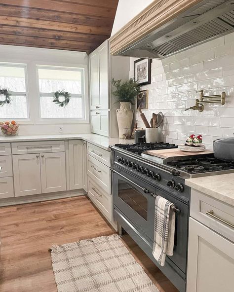 Crown molding will never go out of style, and it's possible to have it installed in a beautiful wood tone versus a classic white. This trim style can double as a bounteous accent to an oversized white range hood. Don't be afraid to mix wood tones either, as it's obvious the soft hardwoods, vent trim, and ceiling panels all highlight various styles of brown. White Vent Hood, Mix Wood Tones, White Range Hood, White Range, Trim Styles, Vent Hood, Wood Tones, Cozy Kitchen, Ceiling Panels