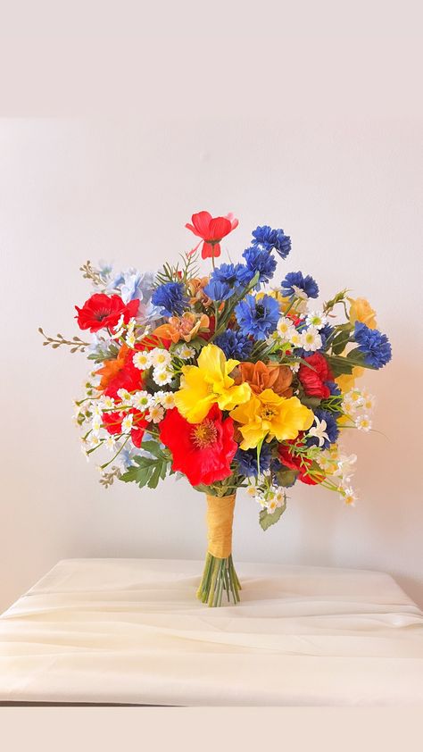 A large wedding bouquet of silk flowers will ideally complement your bridal look.  This bouquet perfectly symbolizes summer nature, which blooms under the hot sun. The bouquet includes red and yellow poppies, blue cornflowers, field chamomile and delicate greenery.   Size: Height 16" Width 15" You can also order a set of wedding accessories (boutonnieres, bracelets, bridesmaid bouquets or a flower hair comb and hair crown)💛 Silk Flower Poppy Bouquet, Red Yellow Blue Flower Arrangements, Red Yellow Blue Bouquet, Red Purple Blue Wedding Bouquet, Red Blue Yellow Wedding, Red Tulip Wedding Bouquet, Multicolor Wedding Bouquet, July Wedding Bouquet, Mexican Flower Bouquet