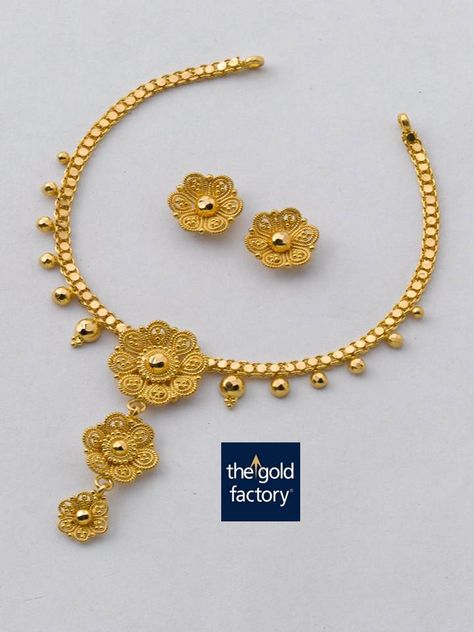 A playful twisted wire three-flowered necklace in 22K hallmarked gold that is an excellent example of how lightweight jewellery can also be a work of art. And every Gold Factory creation is just that.  Necklace weight 11 gm and price Rs.32,900/- Earring weight 4 gm and price Rs.11,900/- Lightweight Jewellery, Gold Factory, Nameplate Necklace Silver, Friends Bridal, Pendant Choker Necklace, Fine Gold Jewelry, Fancy Necklace, Gold Pendant Jewelry, Gold Jewelry Sets