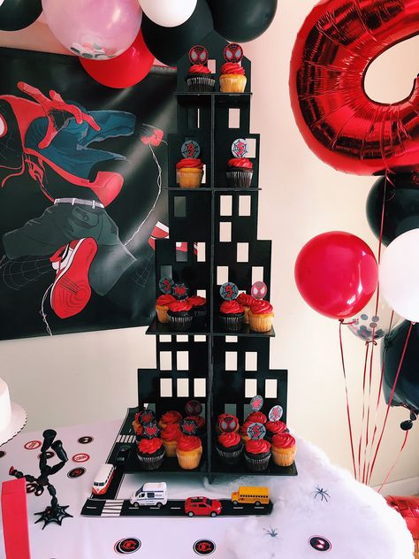 Skyline Cupcake holder + custom cupcake toppers Miles Morales themed birthday party Credit: @wokeartmom on IG. #birthdaypartythemes #milesmorales #spiderman #birthdaypartyideas Spiderverse Themed Party, Black Spider Man Party Ideas, Miles Morales Goodie Bags, Miles Morales Decorations, Spider Man Miles Morales Birthday Party Ideas, Spiderman Birthday Party Miles Morales, Miles Morales Theme Party, Miles Morales Party Favors, Miles Morales Bday Party