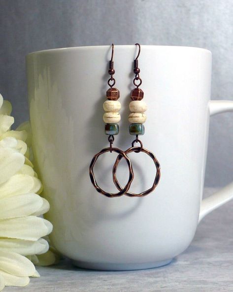 Rustic boho earrings, featuring white howlite and glazed ceramic beads, copper ring dangle and accents, and nickle-free antique copper finish ear wires. Handmade in the USA, ready to ship. These are one of my favorite new designs, and I had to claim the first pair for myself. They are so lightweight you might forget you're wearing them - perfect for all your adventures. - Speckled acrylic focal bead with faded finish wood beads, copper accents and dangles - Length: approx. 2 ½ inches (7 cm) from Boho Earrings Diy Handmade Jewelry, Fall Earring Ideas, Bohemian Earrings Diy, Fall Jewelry Ideas, Leather Earrings Ideas, Bead Earrings Ideas, Bead Earrings Diy, Diy Dangle Earrings, Handmade Earrings Diy