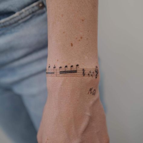 Music Note Wrap Around Tattoo, Note Music Tattoo, Instrument Tattoo Ideas, Tato Music, Meaningful Music Tattoos, Music Arm Tattoo, Marching Band Tattoos, Tattoos For Musicians, Musician Tattoo Ideas