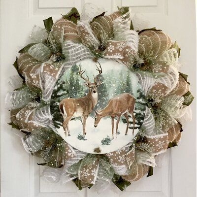 New, full, premium handmade burlap deco mesh winter or holiday wreath. Gorgeous metal winter deer sign rests on a bed of soft white snowdrift deco mesh. Green snowball mesh and burlap snowflake ribbon surround the center. Snow-capped greenery is placed along with the accent. The outer ring is made of burlap mesh with snowdrift cotton stripes. White snowball flutes and beautiful green deer ribbons surround the exterior. | The Holiday Aisle® Winter Deer Handmade Wreath Burlap / Deco Mesh in Brown Winter Deer, Deco Mesh Christmas Wreaths, Christmas Mesh Wreaths, Xmas Wreaths, Greenery Wreath, Welcome Wreath, Handmade Wreaths, Mesh Wreath, Christmas Wreaths Diy