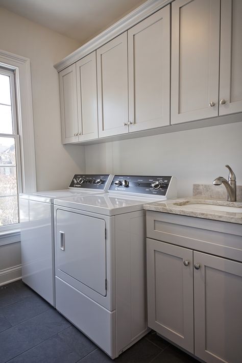 We renovated a basic beige builder house into a fresh new home, including this crisp and clean laundry room. Click to see more of this fantastic project! Beige Cabinets Laundry Room, Side By Side Washer Dryer, Clean Laundry Room, Light Grey Cabinets, Cabinets Laundry Room, Traditional Laundry Room, Light Gray Cabinets, Beige Cabinets, Warm Beige