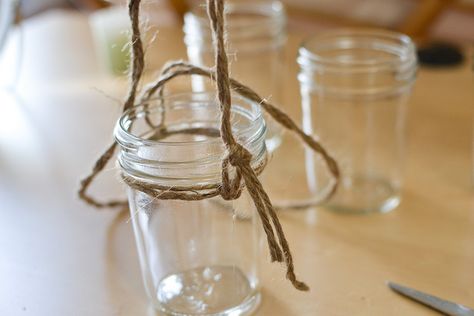 directions on how to make simple twine mason jar lanterns- re pinning because it reminds me of my wedding :) We had a bunch of these in different sizes and shapes with electric candles inside hanging from trees and such Mason Jar Hanging Candles, Make Lanterns, Diy Crafts To Sell On Etsy, Mason Jar Hanging, Jar Hanging, Diy Patio Pavers, Hanging Jars, Beach Wedding Decorations Reception, Mason Jar Lanterns