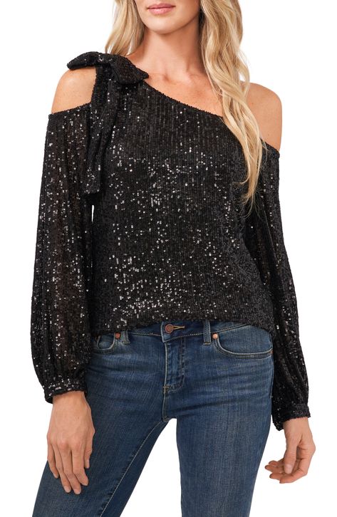 Get ready to dazzle in this sparkling, sequined top that drapes delicately from one shoulder and finishes with a feminine bow atop the other. 20" length (size Medium) Lined, except sleeves One-shoulder neck Long sleeves 97% polyester, 3% spandex Hand wash, dry flat Imported Women's Clothing Sequin Top Outfit, Sequin Blouse, Sequin Bow, Long Sleeve Sequin, Top Outfit, Bow Blouse, Party Tops, One Shoulder Tops, Sequin Top