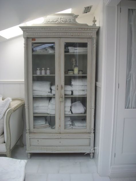 Repurposed glass-front armoire is used for storage in the bathroom - Full Bloom Cottage: Romantic French Cottage.... Glass Bathroom Cabinet, Decorating With Antique Furniture, Baños Shabby Chic, Linen Cupboard, Bathroom Linen Cabinet, Linen Cabinet, Antique Cabinets, Glass Cabinet Doors, French Cottage