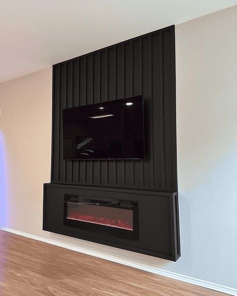 To help you, here are 17 electric fireplace ideas to modernize your space. Electric Fireplace In Basement Ideas, Under Tv Electric Fireplace, Basement Tv Wall With Electric Fireplace, Wall Hung Electric Fireplace Ideas, Two Sided Electric Fireplace, Electric Fireplace In Basement, Electric Fireplace With Accent Wall, Electric Fireplace Tile Surround, Half Wall Electric Fireplace Ideas