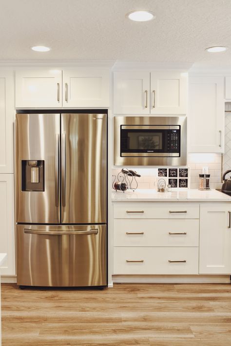 Step into a world of stunning design and innovation with this white kitchen. From modern, bright under cabinet lighting to shaker style cabinets, our comprehensive kitchen remodel process will help you create a beautiful space reflecting your taste and lifestyle. Explore our top picks for subway tile backsplashes, marble countertops, silver cabinet hardware, and wood floors that will make your home the envy of the neighborhood. Check out our website to see how we can make your vision a reality! Kitchen Silver Hardware, White Kitchen Silver Hardware, Silver Cabinet Hardware, Kitchen Silver, Shaker Style Cabinets, Kitchen And Bath Remodeling, Under Cabinet Lighting, Cabinet Lighting, Bath Remodel