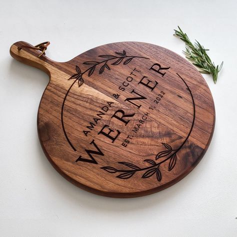 Looking for a unique and thoughtful housewarming gift? Look no further than this charcuterie board! Made from reclaimed wood and featuring a variety of meats, cheeses, and crackers, this board is sure to impress your guests. #charcuterie #housewarminggift Engraved Charcuterie Board Wedding Gift, Wedding Gift Charcuterie Board, Wood Burning Projects Ideas, Laser Engraved Gift Ideas, Cricut Charcuterie Board, Wedding Laser Cut Ideas, Wood Burning Wedding Gift, Wood Burning Gift Ideas, Wood Engraving Ideas