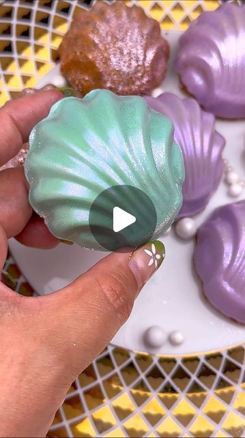 Maria Gomez on Instagram: "I had a craving for brown butter Earl Grey lavender Madeleines so I thought why not use the cute seashell Madeleine pan I’ve had and never used. They look like little soaps. I used @stoverandcompany eleven o’one deluxe white melting wafers for the coating and dusted them with @fancysprinkles moonstone iridescent prism powder. #madeleine #madeleines #cookiedecorating #dippedtreats #littlemermaid #thelittlemermaid #cookies #treatbox #treatboxes" Seashell Madeleine, Lavender Madeleines, Earl Grey Lavender, Maria Gomez, Cute Seashell, Sea Party Ideas, Grey Lavender, Mermaid Under The Sea, Under The Sea Party