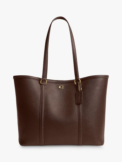 The classic tote reimagined for the new season, pick this trusty piece from Coach. Whipped up from smooth and dreamy leather that's made to last, it fastens with a magnet. Coach Brown Tote Bag, Uni Bags Handbags, Coach Bag Brown, It Bags 2024, Brown Purse Aesthetic, Uni Bag Aesthetic, Cute Bags Aesthetic, Coach Bags Aesthetic, Coach Clothes