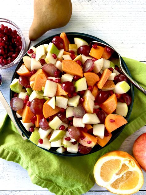 This easy Thanksgiving Fruit Salad is a fun, festive holiday recipe! Apples, pears, persimmons, grapes and pomegranate seeds are tossed in a simple maple orange dressing that prevents the fruit from browning. So you can make it ahead of time! It's great for kids and adults alike. Plus it includes lot of substitution ideas so you can customize it however you want. Fruit Salad For Thanksgiving, Pear Fruit Salad, Salad For Thanksgiving, Thanksgiving Fruit Salad, Paleo Stuffing, Thanksgiving Fruit, Orange Dressing, Juicy Pork Tenderloin, Persimmon Fruit