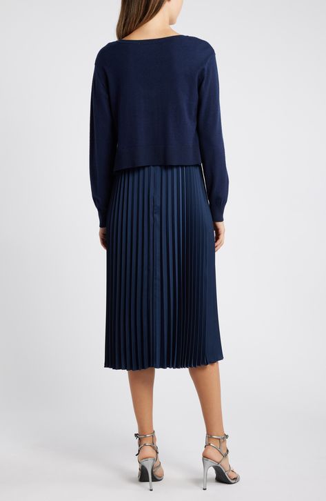 Achieve a layered look in this sophisticated set featuring a polished V-neck sweater and a gracefully moving pleated skirt. Sweater has V-neck; long sleeves; ribbed cuffs and hem Sweater is 48% rayon, 31% polyester, 21% nylon; skirt is 100% polyester Dry clean Imported