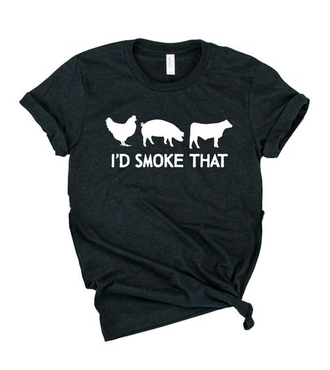 An illustrated t-shirt design featuring a playful chicken, pig, and cow with the text 'I'd Smoke That.' Perfect for grill masters and barbecue enthusiasts. The design is set against a light gray background. Simply Jules, Girly Shirts, Funny Family Shirts, Funny T Shirt Sayings, Chat Halloween, 50th Clothing, Aunt T Shirts, Clothing Shops, Mom Tshirt