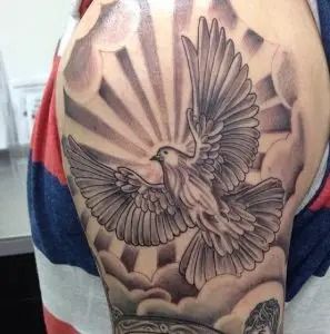 Sunburst Tattoo: Meaning, Placement & Design Ideas - Tattoo Twist Tattoos On Shoulder, Religious Tattoo Sleeves, Clouds Tattoo, Dove Tattoo Design, Skull Rose Tattoos, Dove Tattoos, Dove Tattoo, Bird Tattoos, Men Tattoos Arm Sleeve