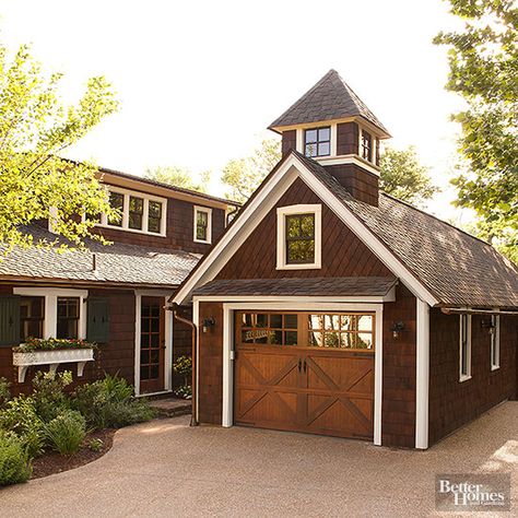 Plenty of modern-day garage upgrades do a good job recalling more traditional garage features. Here, the pretty wood door -- made to resemble closures on a barn or horse stable -- is actually a contemporary roll-up entry. Rich shake shingles set at an angle on the upper half of the garage and a pop-up window cupola also tie the structure to the home. Deur Makeover, Detached Garage Designs, Casa Garage, Plan Garage, Garage Floor Paint, Garage Addition, Wood Garage Doors, Mudroom Decor, Barn Garage