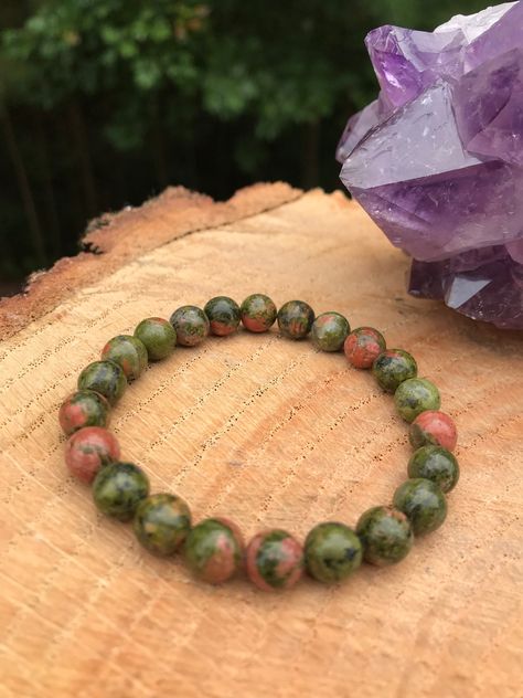 Genuine Unakite stretch bracelet with smooth round 6mm, 8mm, 10mm or 12mm gemstone beads. Please note the stone shade, color, and pattern may vary since we are working with genuine stones no two are alike. Listing is for ONE bracelet and will come in a drawstring bag with gift box. UNAKITE: Unakite brings together the abundant, nurturing energy of green with the soft, caring passion of pink in one of Nature's most healing crystals of the heart and mind. It resonates with the frequency of love, c Emotional Balance, Heart And Mind, Spiritual Healing, Chakra Healing, Healing Crystals, Atlanta Ga, Bead Designs, Fertility, Immune System