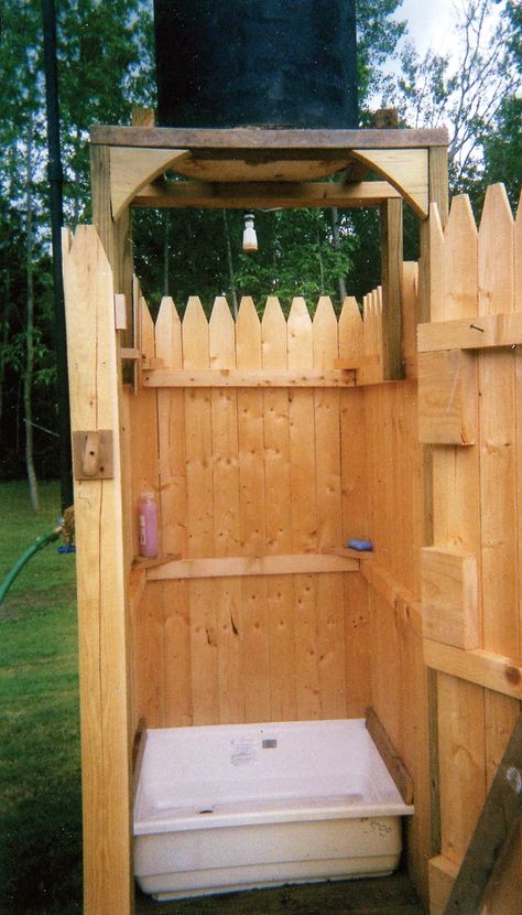 The water for this homemade outdoor shower is heated by the sun, saving you money and energy. You can build it with a bit of lumber, a used 50-gallon drum, and a few plumbing parts from the hardware store.data-pin-do= Solar Shower Diy, Outdoor Solar Shower, Solar Shower, Portable Shower, Camping Shower, Mother Earth News, Diy Shower, Diy Solar, Camping Survival