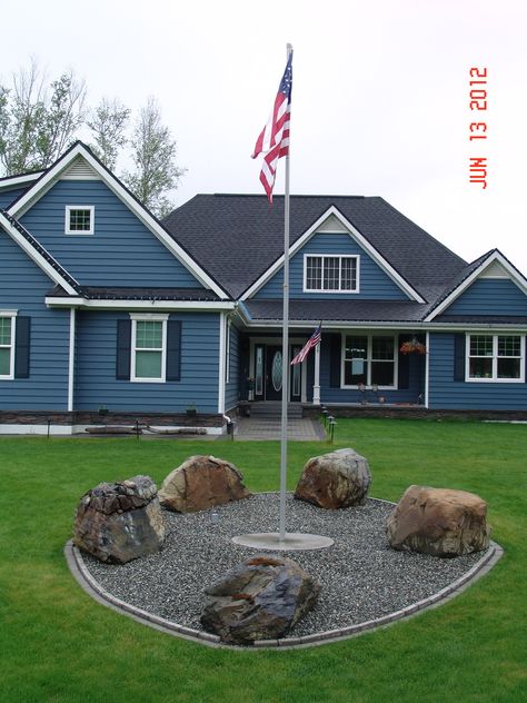 Our front yard with our new flag pole. Front Yard Flagpole Ideas, Landscaping Around Flagpole Front Yards, Circle Driveway With Flag Pole, American Flag Pole Landscaping, How To Put A Flag Pole In The Ground, Flag Pole Landscaping, Flagpole Landscaping Ideas, Cheap Landscaping Ideas, Natural Landscaping