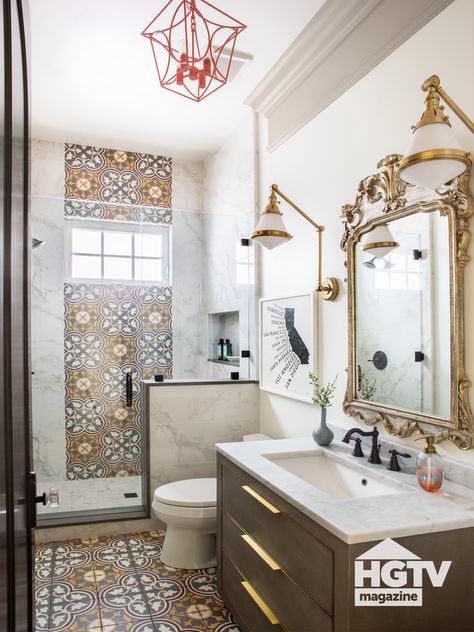 This Spanish style bathroom is decorated with beige and white tile, a gold rimmed mirror and a red pendant. Take a full house tour on HGTV.com. Veranda Interiors, Spanish Style Bathrooms, Spanish Bathroom, Coronado California, Main Bathroom Ideas, Bathroom Stand, California House, Hgtv Magazine, Bad Inspiration