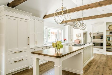 Benjamin Moore White Dove cabinets surround a wooden breakfast island countertop merging into an island with a cooktop. White Dove Kitchen, Benjamin Moore Cabinets, Breakfast Island, Kitchen Decor Countertop, Kitchen Island With Cooktop, Painting Kitchen Cabinets White, Diy Kitchen Cabinets Painting, Kitchen New York, Painted Kitchen Cabinets Colors