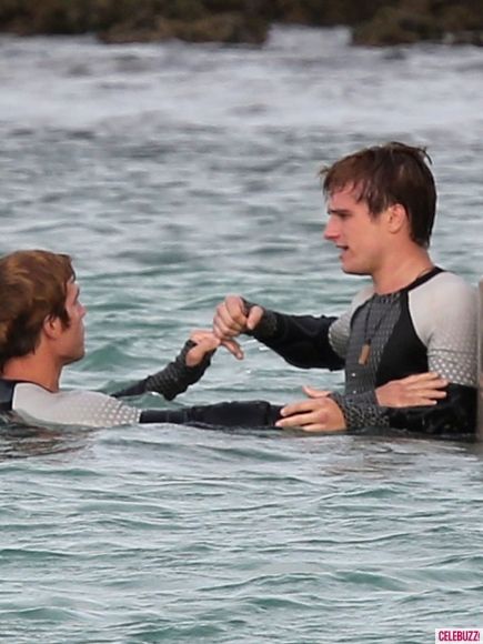 Katniss, Peeta, Finnick, & Mags In Catching Fire Set Photos | The Mary Sue Josh And Jennifer, Hunger Games Cast, Finnick Odair, Katniss And Peeta, Sam Claflin, Hunger Games 3, Hunger Games Series, Peeta Mellark, Hunger Games Catching Fire